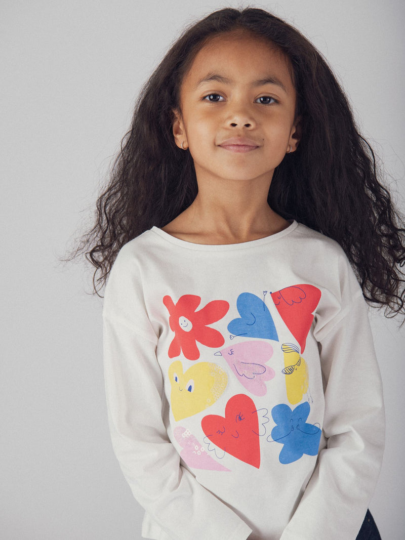 Langarmshirt in Ecrufarbe mit bunten Animationen für Mädchen